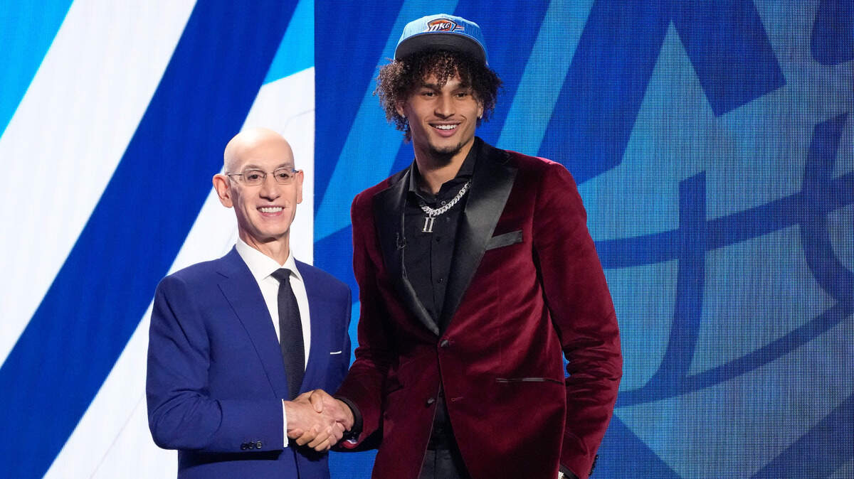 Dereck Lively II poses for a photo with NBA Commissioner Adam Silver after being selected 12th overall in the draft on Thursday. 
