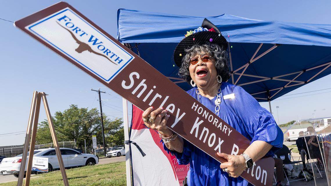 Former Dunbar principal Shirley Knox Benton reacts to seeing her street topper during a dedication ceremony in her honor outside Dunbar High School in Fort Worth on Thursday, Oct. 2, 2025. The tribute highlights Benton's lasting impact on Dunbar and its role in the broader Fort Worth community.
