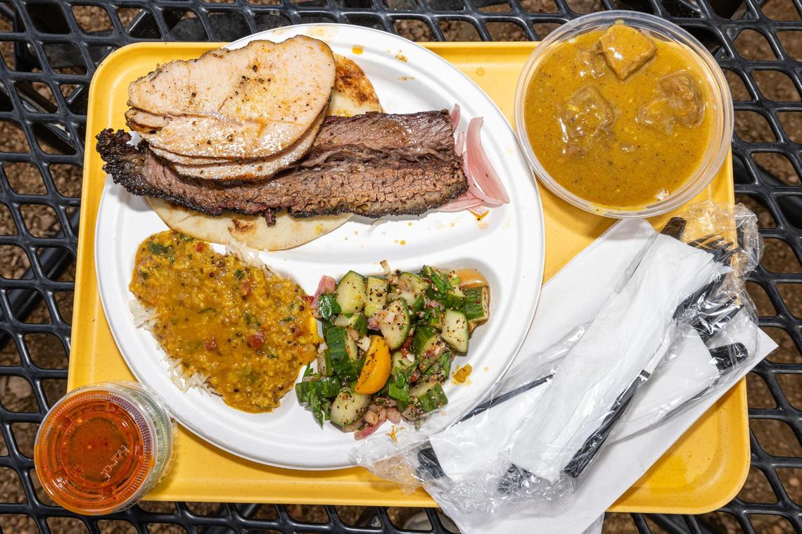 A three-meat plate with tandoori turkey, brisket and burnt ends nihari with a side of daal chawal (lentils over rice) and kachumber salad from Sabar BBQ in Fort Worth. Columnist Bud Kennedy says it’s one of the best barbecue places in Fort Worth.