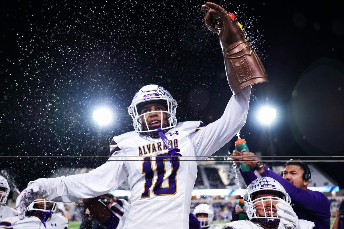 Alvarado defensive back Devin Johnson holds a Infinity Stone hand in celebration after forcing a turnover in a Class 4A Division I area playoff game against Sulphur Springs on Friday, Nov. 21, 2025, at Children’s Health Stadium in Prosper, Texas.