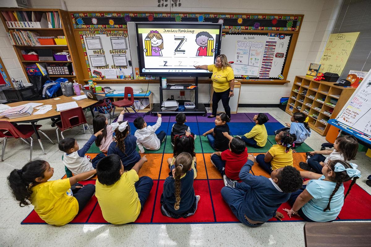 Kindergarten teacher Luz Botello teaches the pronunciations of letters to her class at Annie Webb Blanton Elementary School in Dallas on Tuesday, Oct. 22.