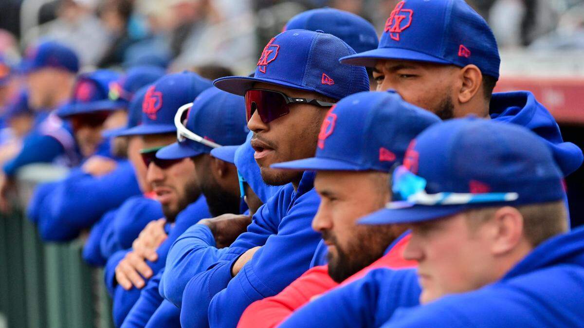 Members of the Texas Rangers look on in the first inning against the San Francisco Giants during a Spring Training game at Scottsdale Stadium.