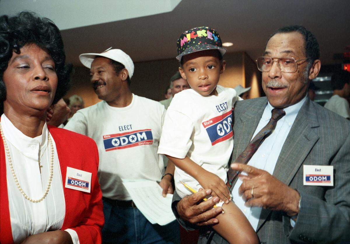 Elzie Odom, right, celebrates with family and supporters after winning an Arlington City Council election by 16 votes on May 19, 1990, to become the city's first Black council member. His wife, Ruby Odom, is on the left.