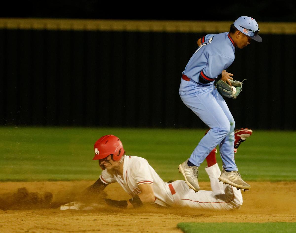 Grapevine right fielder Brady Boozer (9) slides safely under Richland second baseman Kobe Boulom (7) to reach second during a UIL baseball game at Grapevine Mustang Field in Grapevine, Texas, Thursday, Apr. 17, 2025.