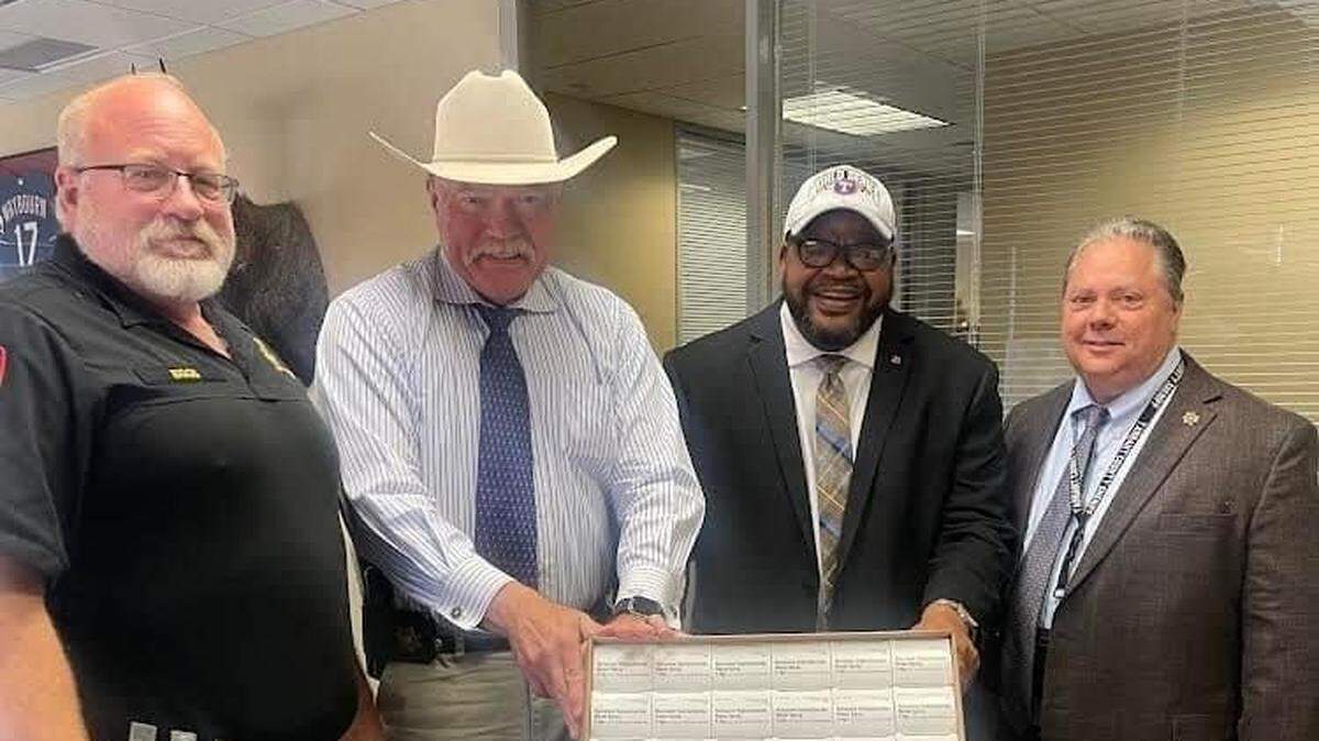 Pastor Kyev Tatum, second from right, receiving Narcan from Sheriff Bill E. Waybourn, second from left, and the Tarrant County Sheriff’s Office. Tatum supports a new training program called SaferCare Texas, which seeks address opioid overdoses.