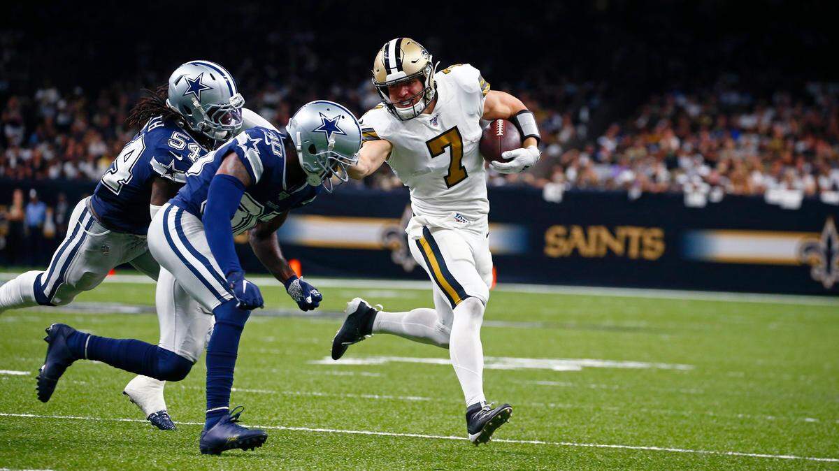 New Orleans Saints’ Taysom Hill carries against Dallas Cowboys middle linebacker Jaylon Smith and cornerback Anthony Brown in the Saints’ 12-10 win Sunday night at the Superdome.