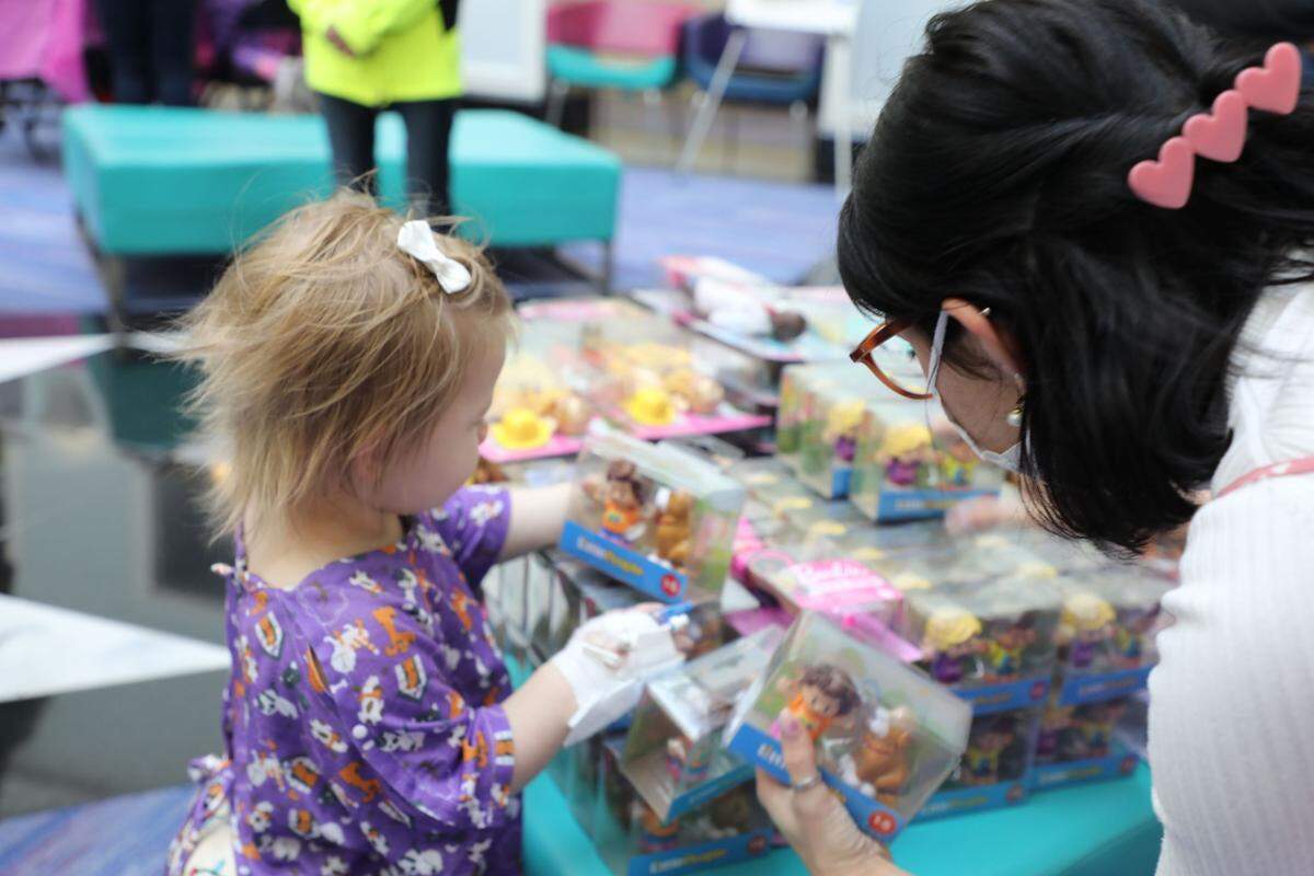Little girl picks out a toy. 