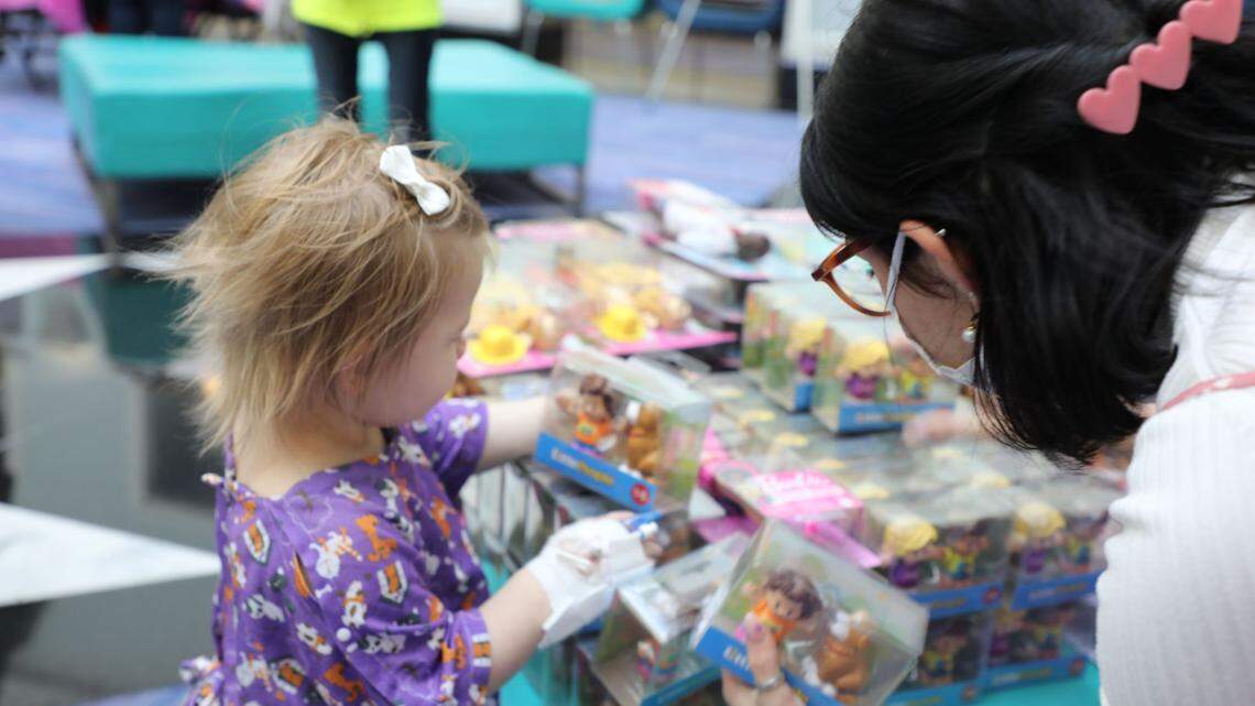 Little girl picks out a toy. 