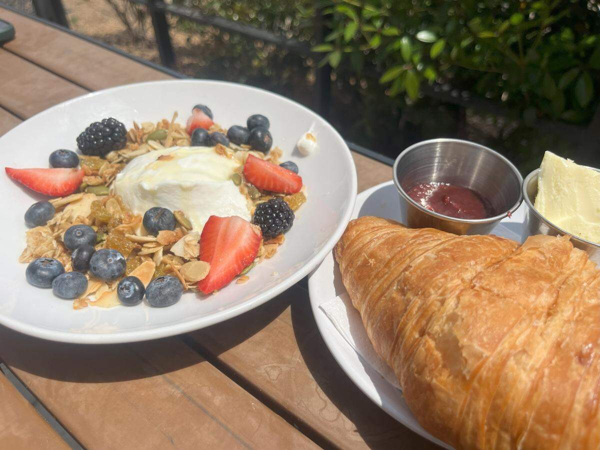 A coconut and granola yogurt bowl with a french croissant from Ascension in Fort Worth.