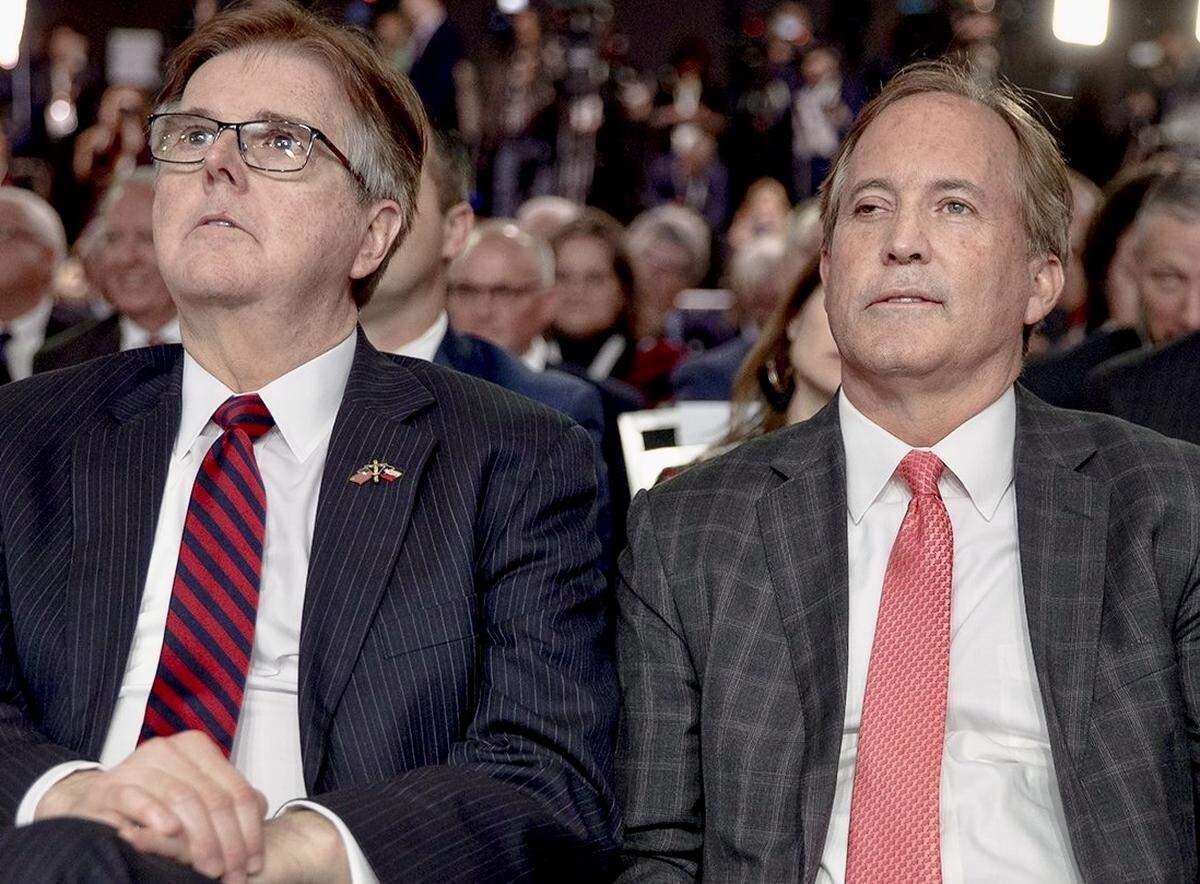 Texas Lt. Gov. Dan Patrick and Attorney General Ken Paxton listen to President Donald Trump speak at the American Farm Bureau Federation convention on Sunday, Jan. 19, 2020, in Austin, Texas. The president’s visit came just two days before an impeachment trial was set to begin in the Senate,