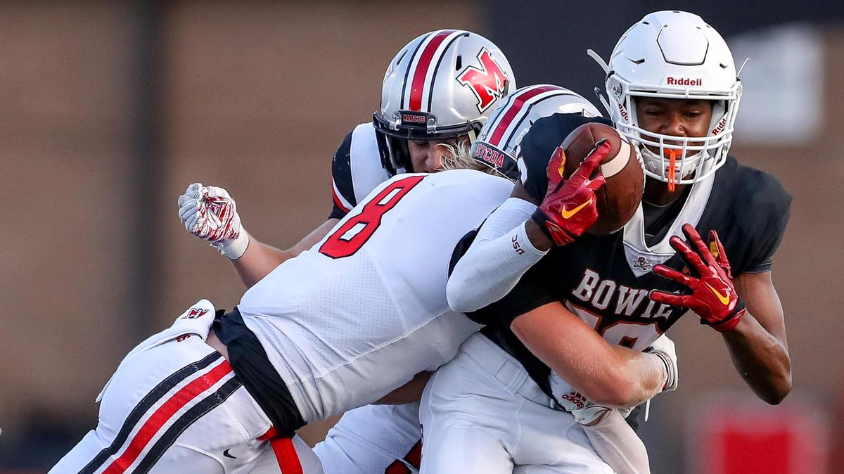 Arlington Bowie wide receiver Jimmy Valsin (18) comes up with a reception and is brought down by Flower Mound Marcus linebacker Ethan Barr (8) during the first half, August 29, 2019 played at Wilemon Field in Arlington, TX.