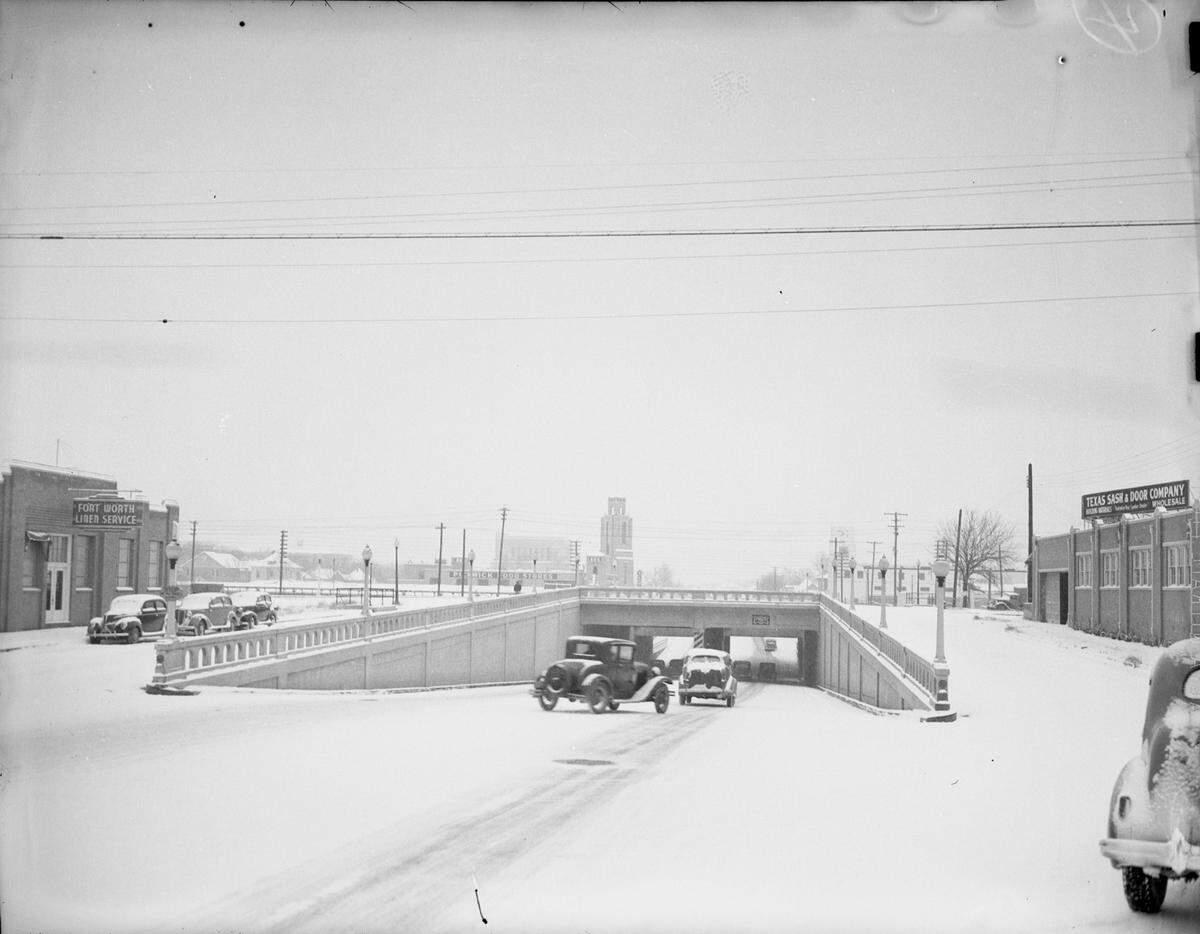 Jan. 22, 1940: “Drivers driving on the Henderson Street went out of their way to avoid the slick inclines leading to the underpass. The ground is covered in snow. Several buildings seen in the background. Published in Fort Worth Star-Telegram, evening edition, January 22, 1940.”