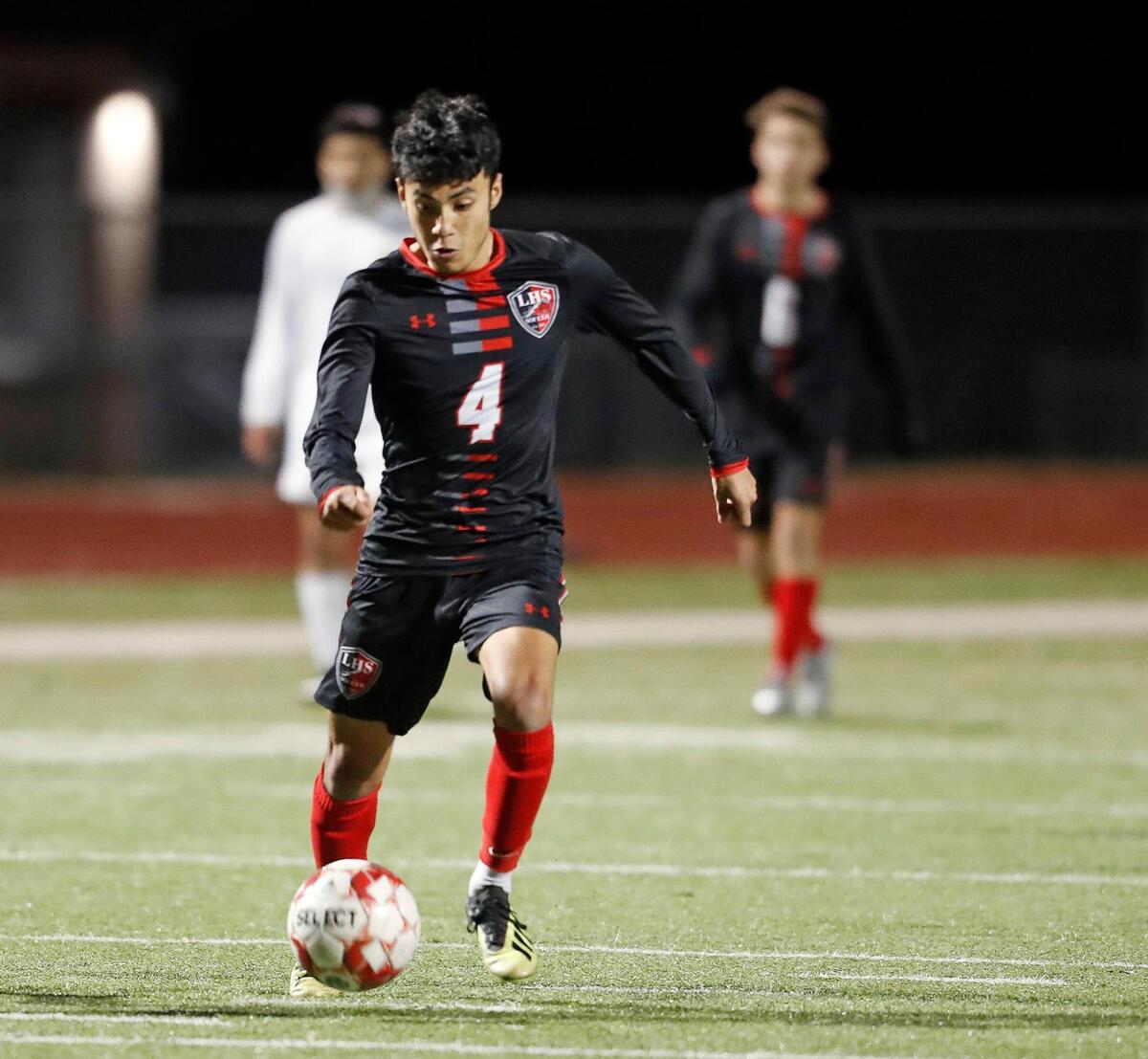 Legacy’s Adrian Lugo (4) brings the ball down the pitch uncontested during a district 8-5A high school soccer game at Mansfield Legacy High School in Mansfield, Texas, Wednesday, March 03, 2021. Legacy defeated Everman 5-1. (Special to the Star-Telegram Bob Booth)
