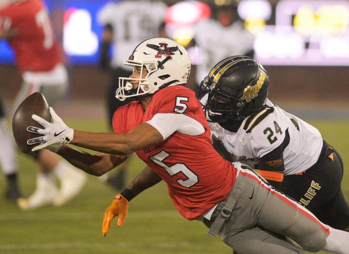 Argyle wide receiver Julian Caldwell (5) makes a diving catch as South Oak Cliff defensive back Tobias Gary (24) attempts to swat the ball during a Class 5A Division II state semifinal on Friday, Dec. 13, 2024 at Gerald J. Ford Stadium in University Park, Texas.