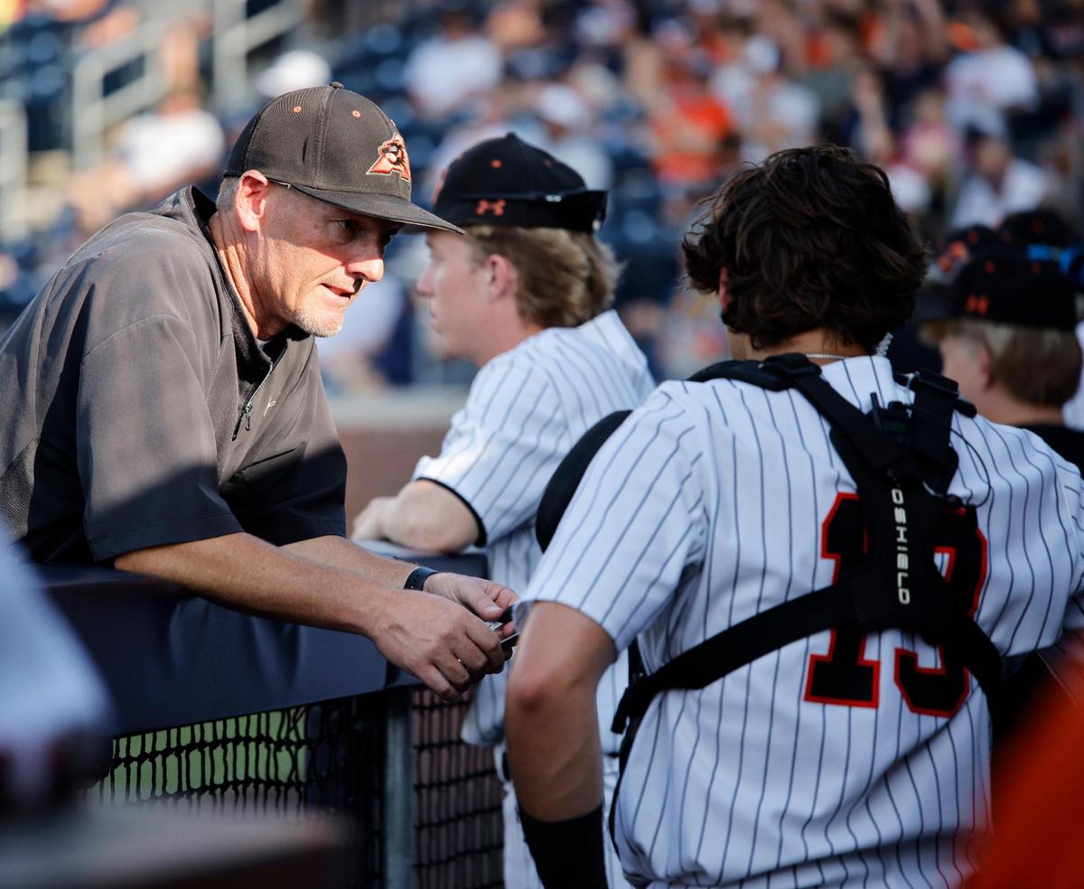 Aledo head coach Chad Barry talks with catcher Brennon Evans (13) between innings of a UIL 5A D1 semifinal baseball game at Dallas Baptist University’s Horner Ballpark in Dallas, Texas, Thursday, May 29, 2025.