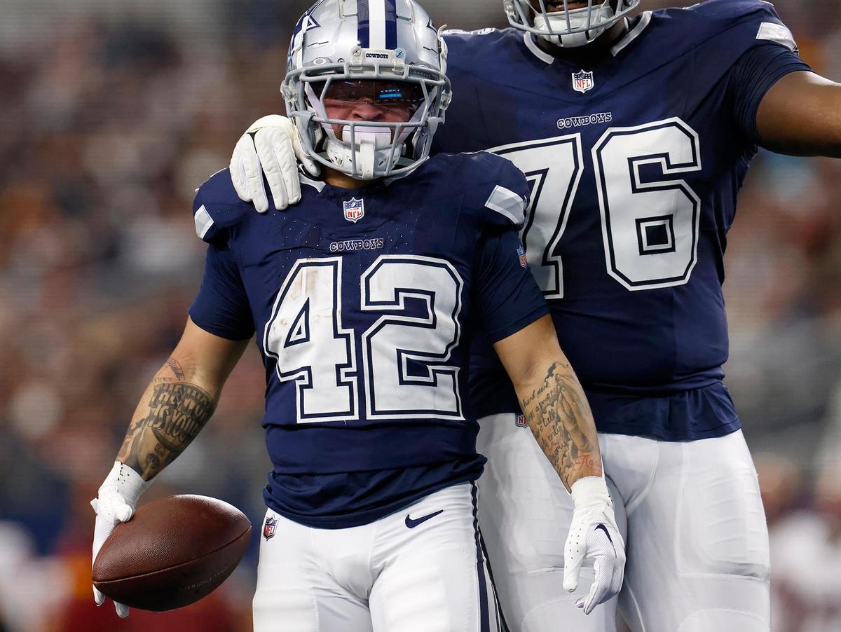Dallas Cowboys running back Deuce Vaughn (42) celebrates a play with teammate Asim Richards on Sunday, Jan. 5, 2025, at AT&T Stadium.