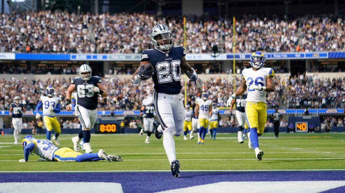Dallas Cowboys running back Tony Pollard (20) reaches the end zone after a long run for a touchdeown as Los Angeles Rams safety Terrell Burgess (26) and others pursue in the first half of an NFL football game, Sunday, Oct. 9, 2022, in Inglewood, Calif. (AP Photo/Ashley Landis)