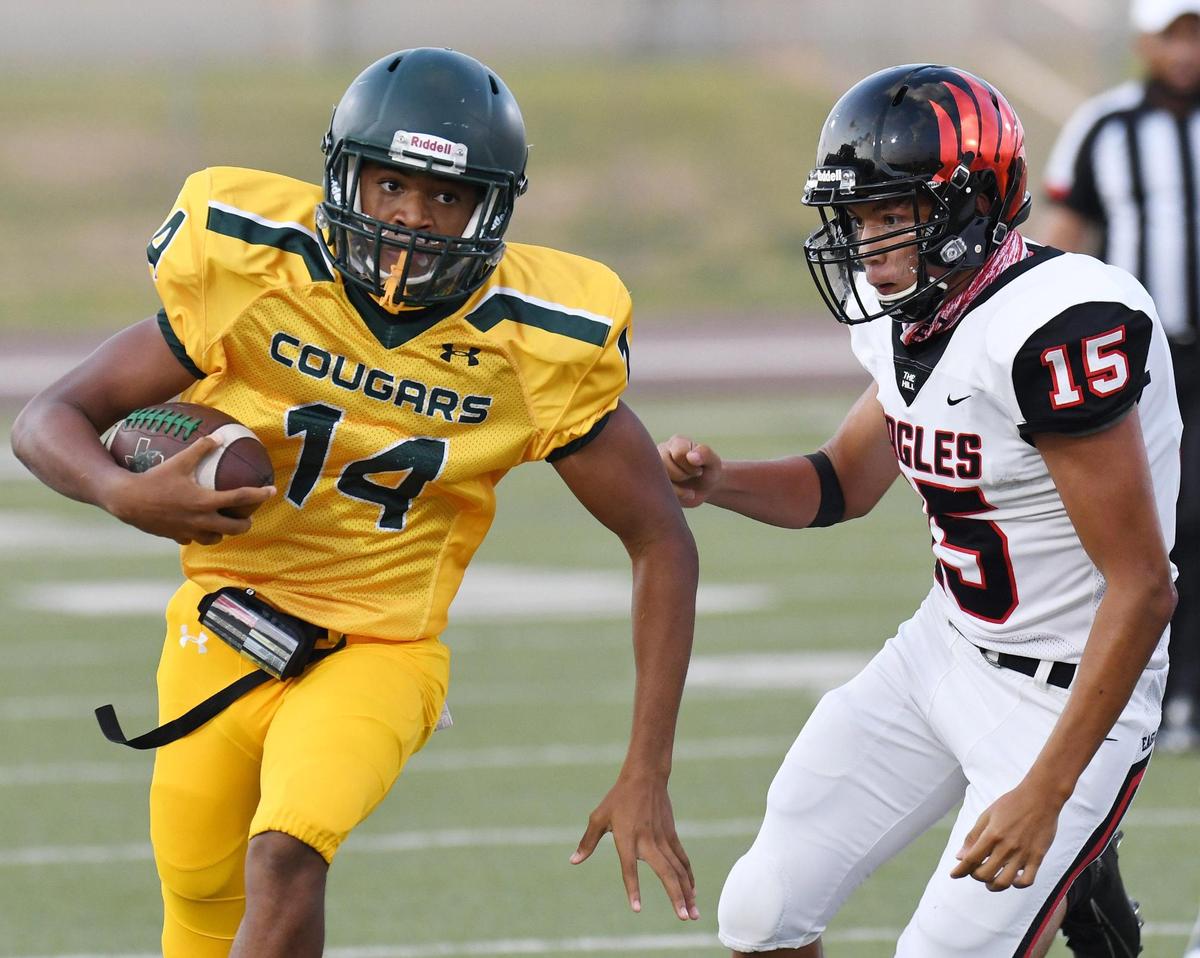 Western Hills’s quarterback Keyon Butler, left races out of the backfield past Diamond Hill Jarvis’s Angel Aldaba for a first down in the first quarterof their football game at Clark Stadium Thursday, September 17, 2020 in Fort Worth, Texas. Special/Bob Haynes