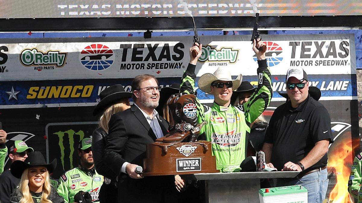 Kyle Busch (18) fires the six shooters after winning the O'Reilly Auto Parts 500 at Texas Motor Speedway Sunday April 08, 2018. Kyle Busch (18) won the 501 lap race.