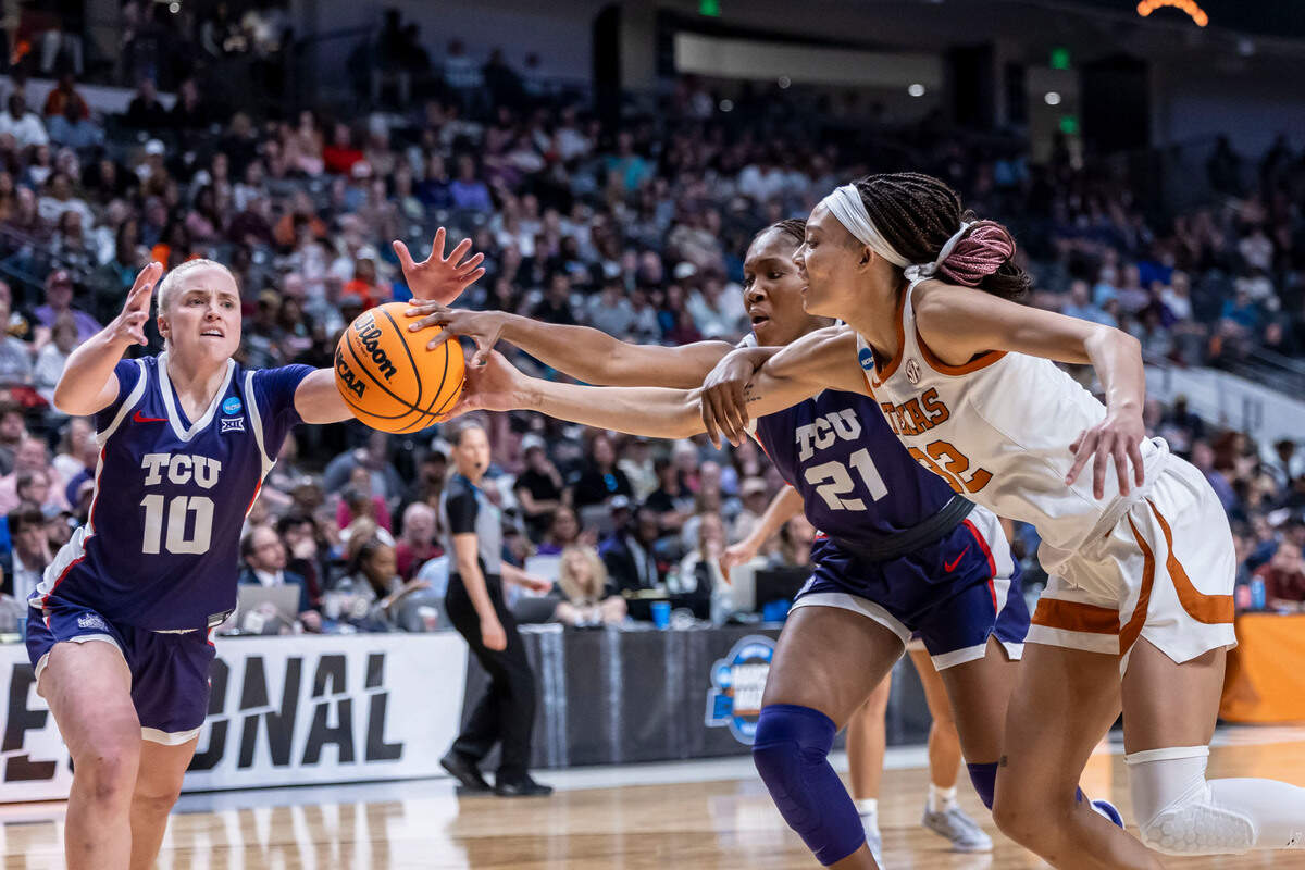 TCU Horned Frogs guards Hailey Van Lith (10) and Agnes Emma-Nnopu (21) battle with Texas Longhorns guard Ndjakalenga Mwenentanda (32) for a loose ball during the first half of an Elite 8 NCAA Tournament basketball game at Legacy Arena.