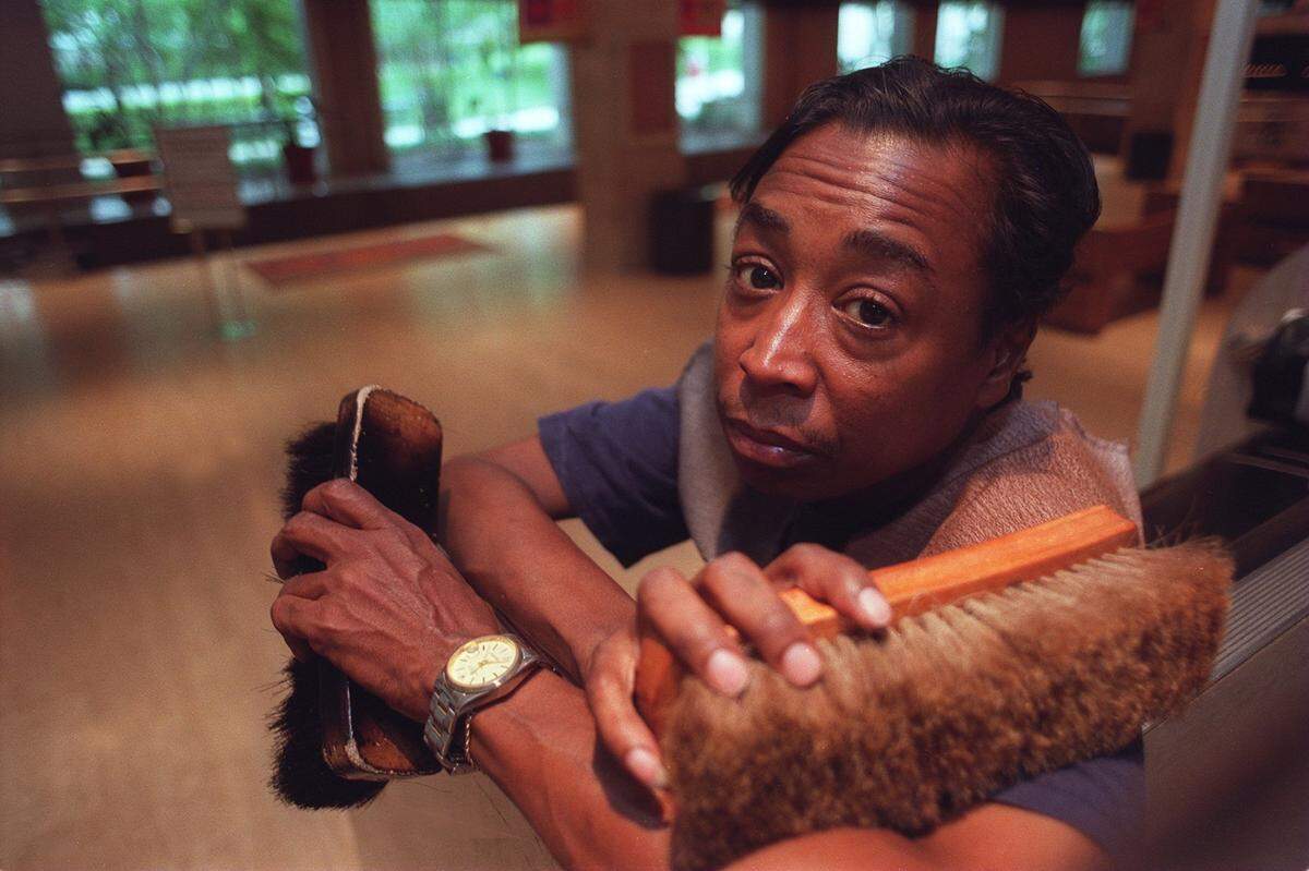 Howard Rivers sits on his shoeshine stand at the Charles D. Tandy Center subway stop where his shoeshine stand business will cease to operate on Aug. 30, 2002, in Fort Worth.
