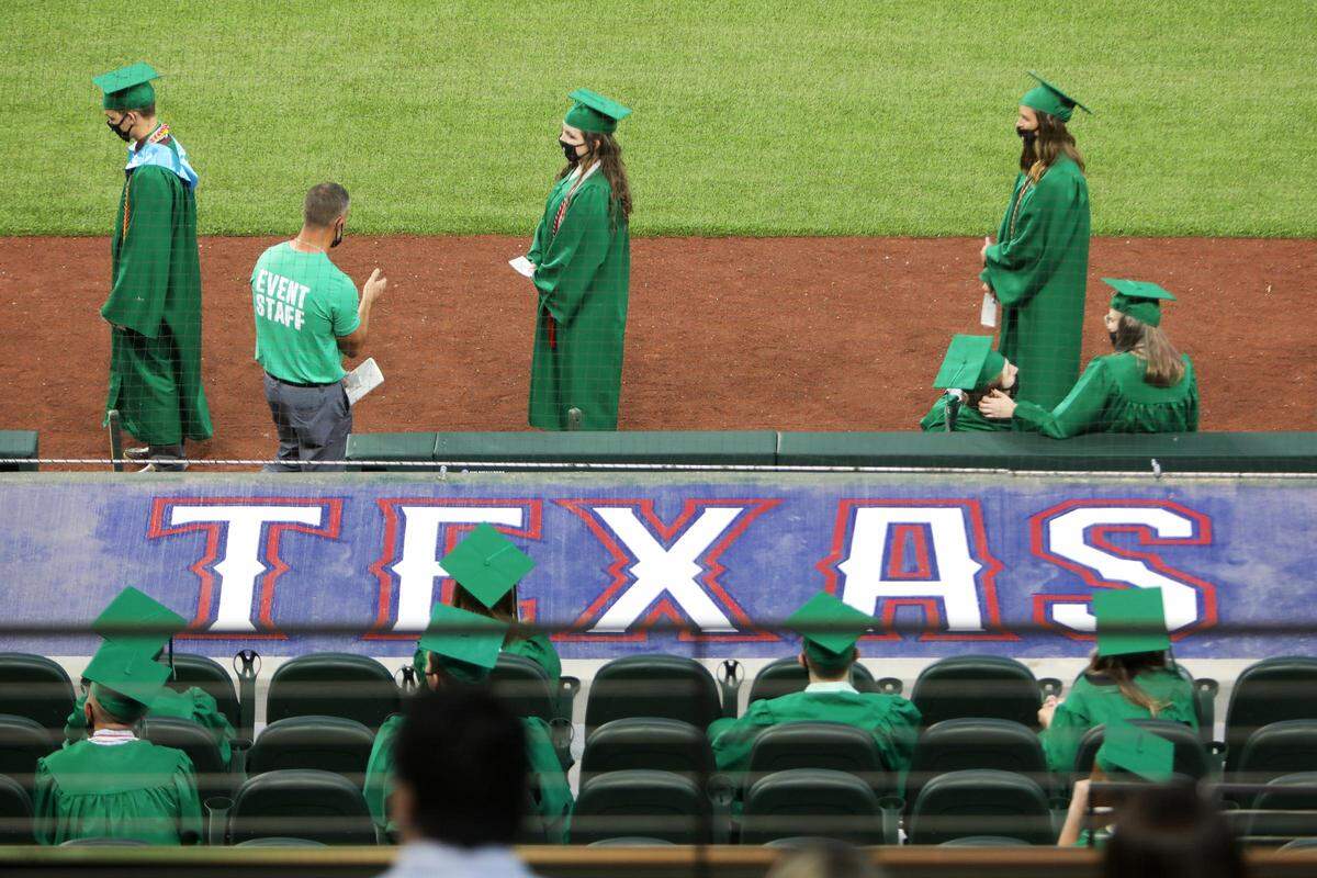 Azle High School seniors walk during their commencement ceremony at Globe Life Field on Saturday, May 30, 2020.