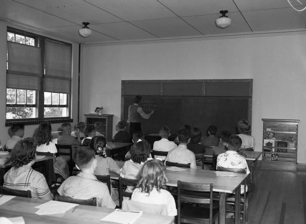 Sept. 11, 1941: The new Sagamore Hill Elementary School on the first day with 172 students from first through sixth grade. Sixth-grade teacher, Miss Mary Ferguson, is shown standing at the chalkboard. She is teaching her pupils about common denominators.