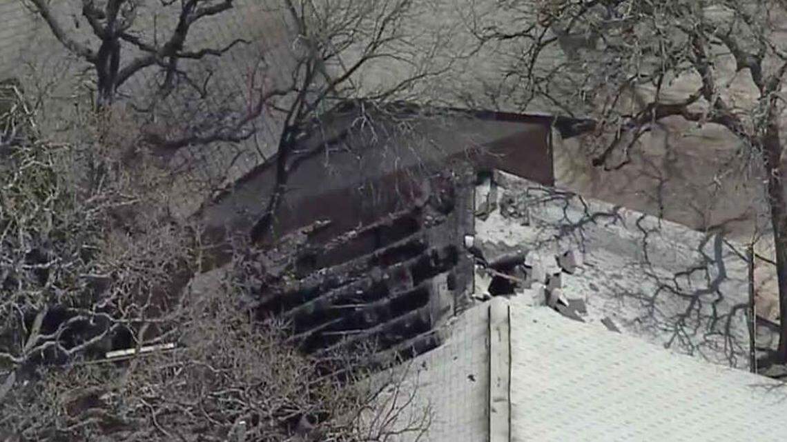 A fire that engulfed two homes in Bedford on Friday killed a woman and injured anther person.