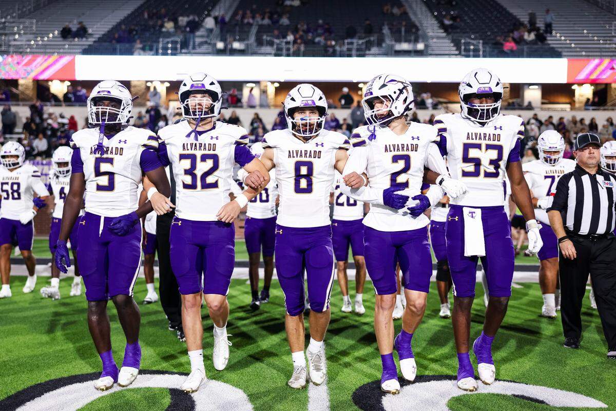 Alvarado captains walk to midfield with arms locked before their Class 4A Division I area playoff game against Sulphur Springs on Friday, Nov. 21, 2025, at Children’s Health Stadium in Prosper, Texas.