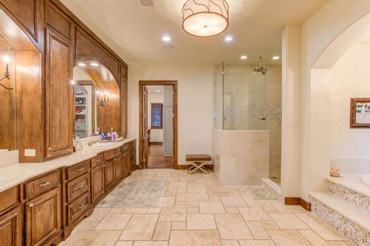The Primary bathroom at 9930 Boat Club Road has a walk in shower with his and her sinks, as well as a grand built in bath tub.