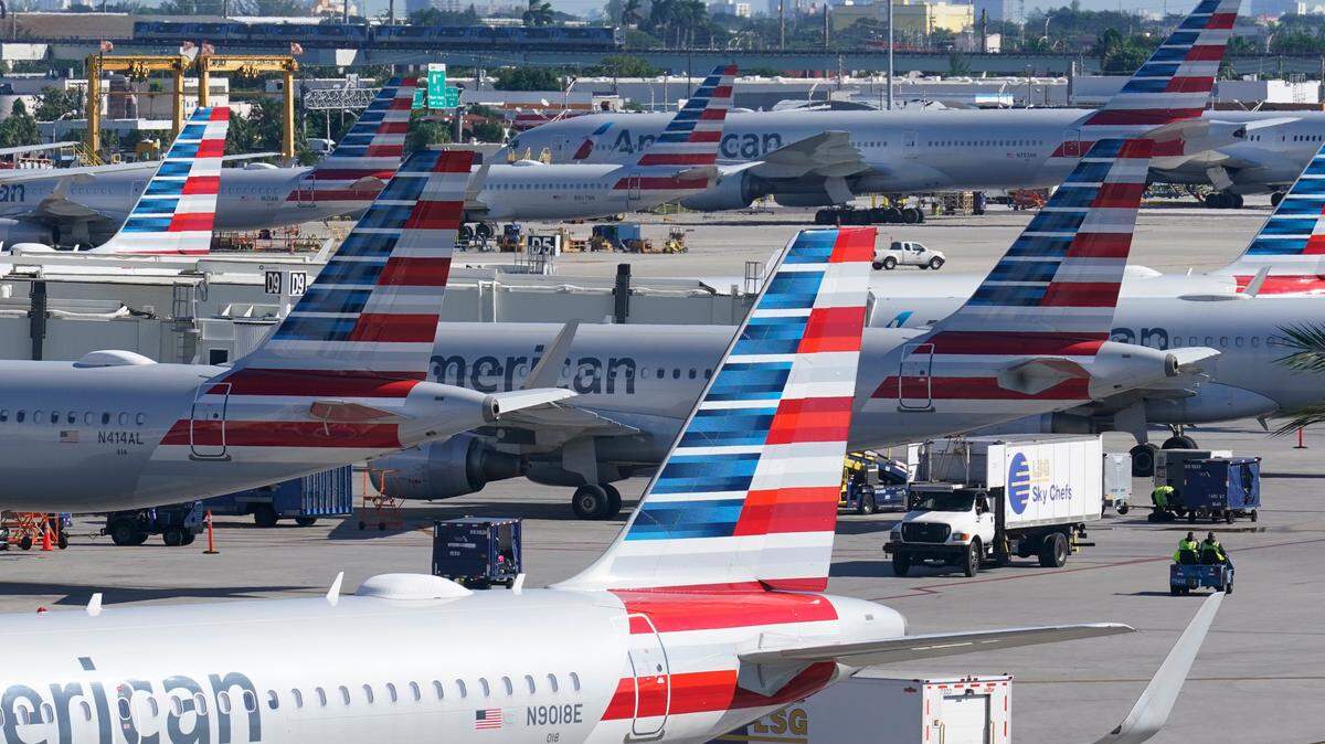FILE - American Airlines planes are parked at Miami International Airport gates, on Nov. 23, 2021, in Miami. (AP Photo/Marta Lavandier, File)