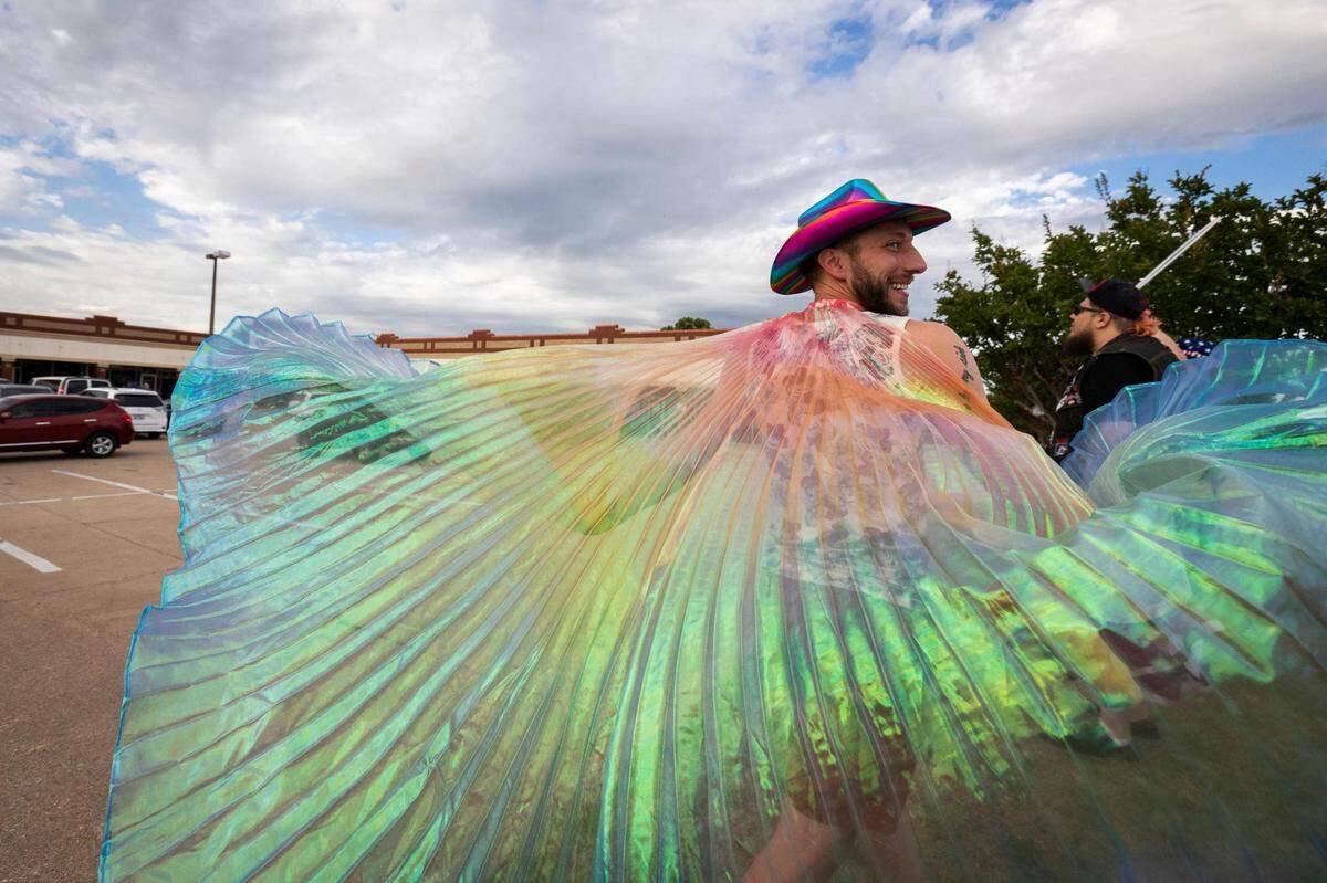 Tyler Huckabee swings his cape around while protesting in front of Stedfast Baptist Church where a pastor preaches against homosexuality Wednesday, June 1, 2022, in Watauga.