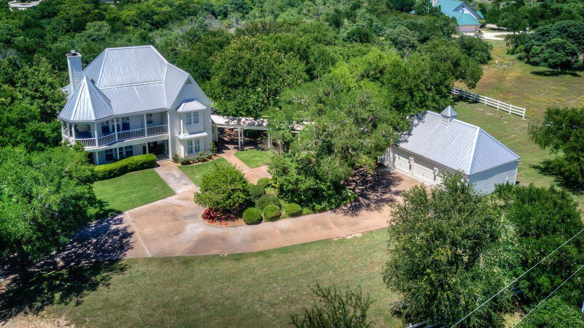 The home at 8451 E Bankhead sits on 10 acres on a heavily treed hilltop with commanding views. 