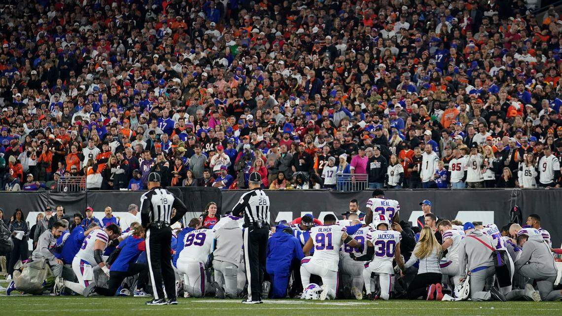 The Buffalo Bills players pray for teammate Damar Hamlin during the first half of an NFL football game against the Cincinnati Bengals on Monday.