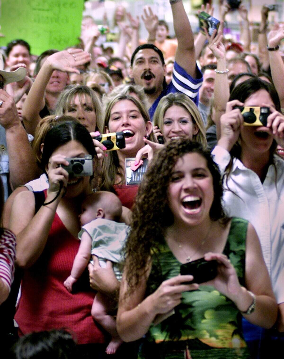 Elbow to elbow fans of country singer Toby Keith reacted as he walked on stage to greet his fans at the Wal-Mart in North Richland Hills on Sunday, July 28, 2002. Toby made an appearance to sing a song, sell CDs and sign autographs.