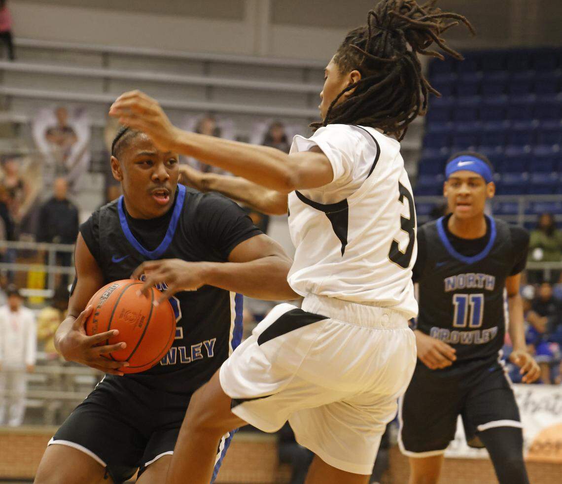 North Crowley guard Kameron Price (2) drives into the paint defended by Mansfield's KT Turner (3) during the first half of a UIL boys basketball game between North Crowley and Mansfield at Mansfield High School in Mansfield, Texas, Tuesday Jan. 20, 2026