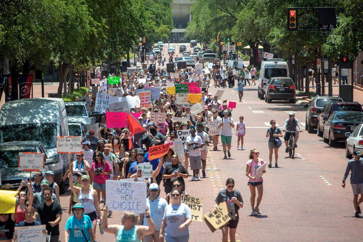Hundreds of abortion-rights advocates march toward the Tarrant County Courthouse at the end of a protest in downtown Fort Worth in June 2022. In a sea of hand-drawn signs, chanting people alternated between “My body, my choice” and “Reproductive rights are human rights.”