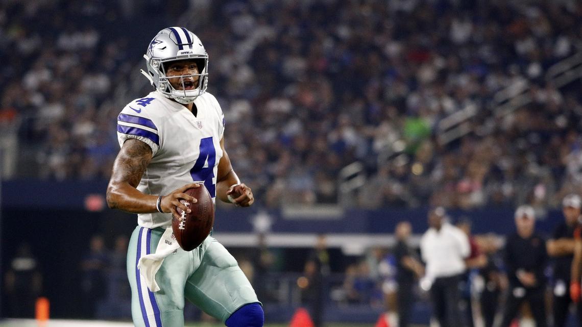 Dallas Cowboys quarterback Dak Prescott (4) scrambles near the goal line to complete a touchdown to wide receiver Terrance Williams (83) in Saturday’s preseason game against the Cincinnati Bengals.