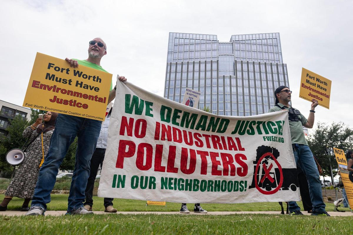 Protesters hold signs in support of the Echo Heights neighborhood outside of the City Hall building in downtown Fort Worth on Tuesday, June 10, 2025. FedEx applied for a conditional use permit to allow parking of semi-trucks and trailers in a part of the Echo Heights neighborhood, prompting a protest by the Fort Worth Environmental Coalition of Communities—a group of residents fighting environmental racism—urging the city to deny the permit.