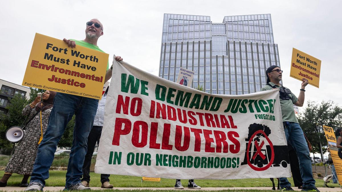 Protesters hold signs in support of the Echo Heights neighborhood outside of the City Hall building in downtown Fort Worth on Tuesday, June 10, 2025.
