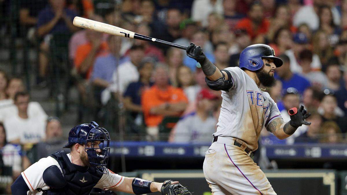 Texas Rangers’ Rougned Odor, right, watches his second home run of the night in front of Houston Astros catcher Max Stassi during the seventh inning of a baseball game Saturday, July 28, 2018, in Houston. (AP Photo/Michael Wyke)