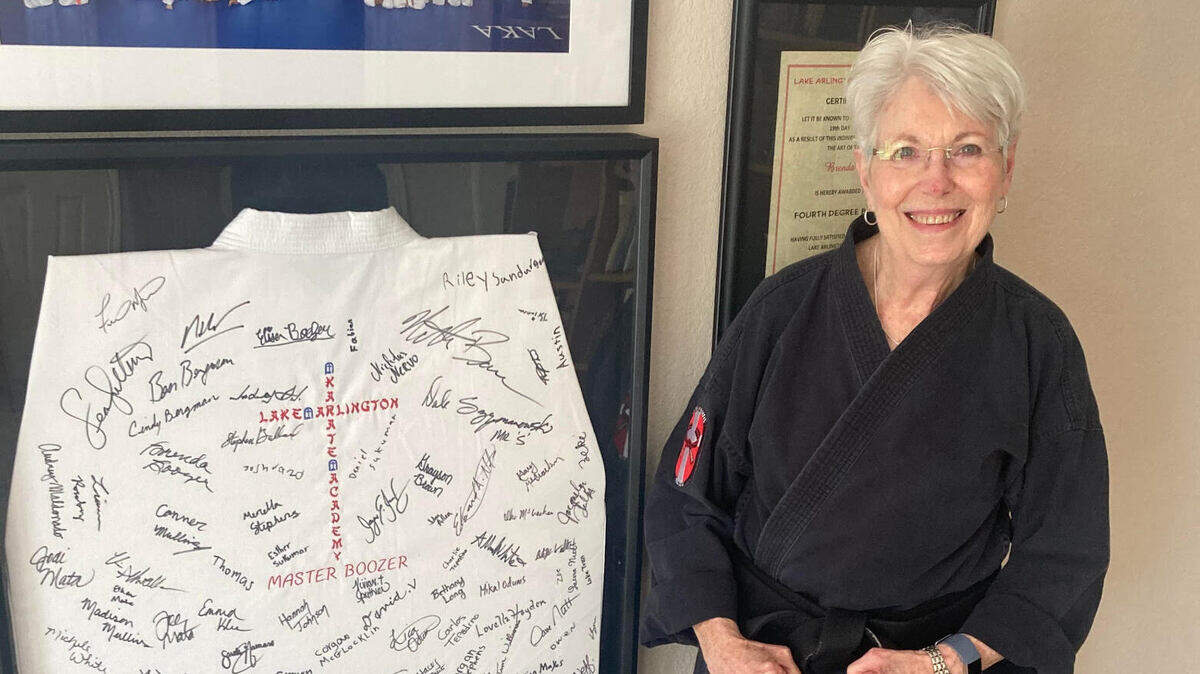 Brenda Boozer, 73, of Arlington became a fifth-degree black belt on Saturday. She is now a master, like her late husband, Jim, whose framed gi hangs in their home.