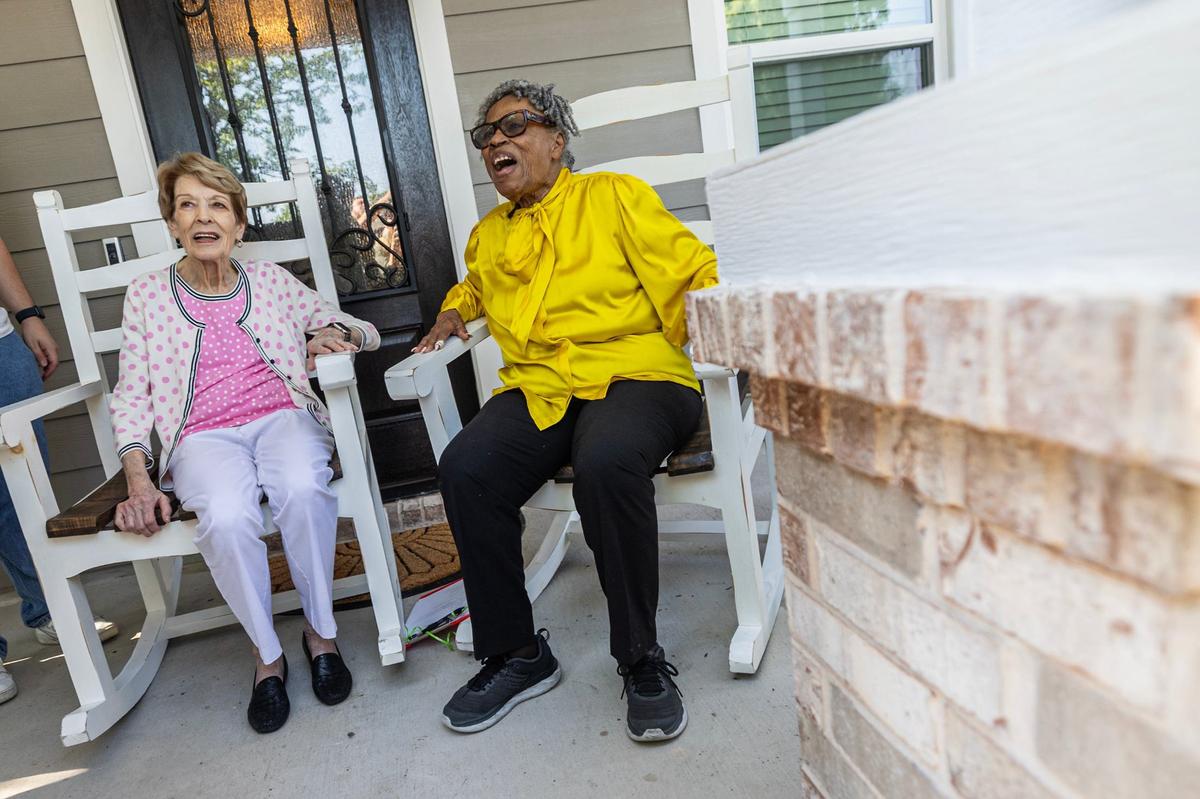Gail Ryan, left, shares a laugh with her longtime friend Opal Lee on the porch of Lee’s new home.