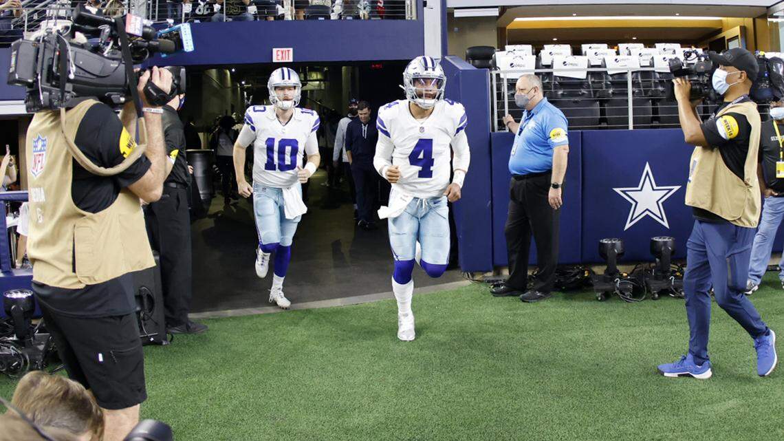 Dallas Cowboys quarterbacks Dak Prescott (4) and Cooper Rush (10), run onto the field prior to a 2021 game.
