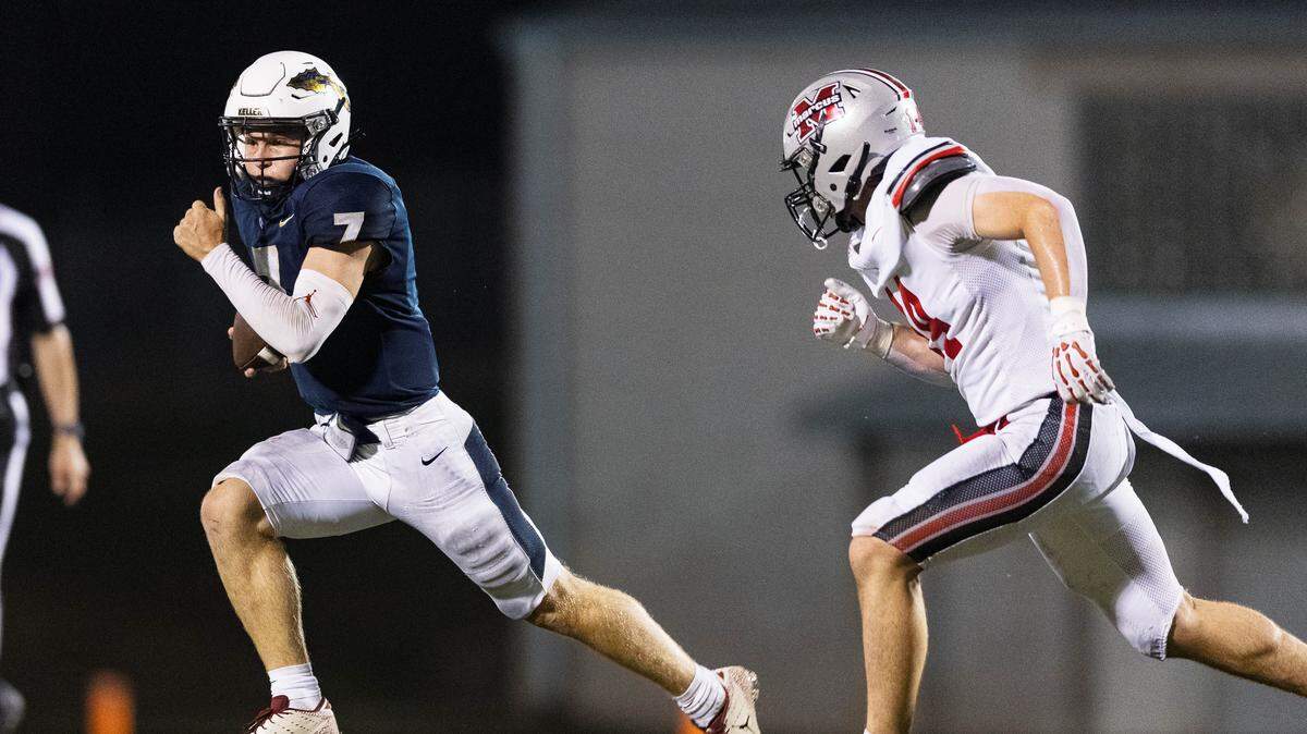Keller quarterback Brock Burkett scrambles away from a Flower Mound Marcus defender during the 4th quarter of a non-district game between Keller and Flower Mound Marcus at Keller ISD Stadium on August 28, 2025.