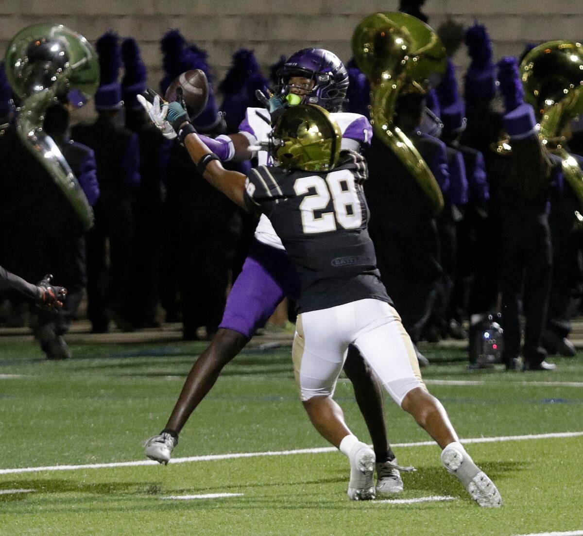 Crowley’s Antayvious Ellis and Mansfield’s Isaiah Odom try to control a defected pass during a UIL football game at Newsome Stadium on Saturday , October 10, 2024.