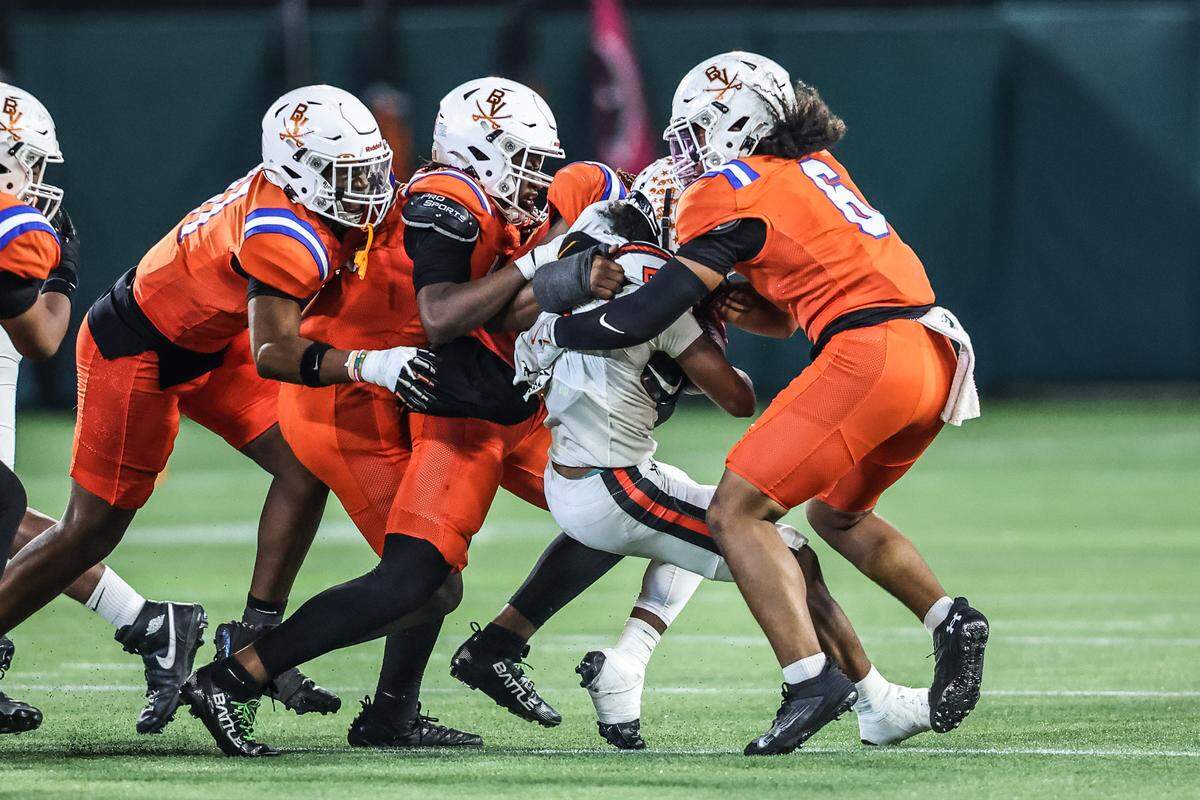 The Arlington Bowie defense wraps up Haltom running back Vudrico Roberson on Thursday.