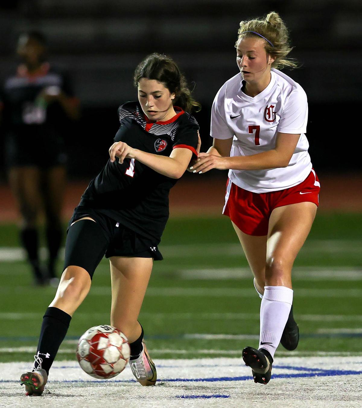 Mansfield Legacy’s Emila Lawson (1) tries to dribble past Grapevine’s Caroline Martin (7) during the first half of the 5A Region 1 area round girls soccer playoffs played on March 30 2021, at Cravens Field in Arlington, TX. (Steve Nurenberg Special to the Star-Telegram)