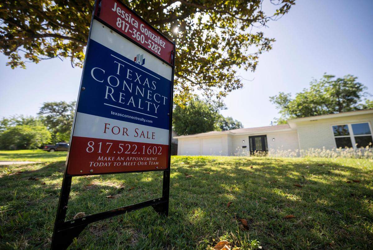 A real estate agent’s sign in front of a house for sale in Fort Worth. The supply of homes is still incredibly low, and experts say rising interest rates won’t lower home prices.
