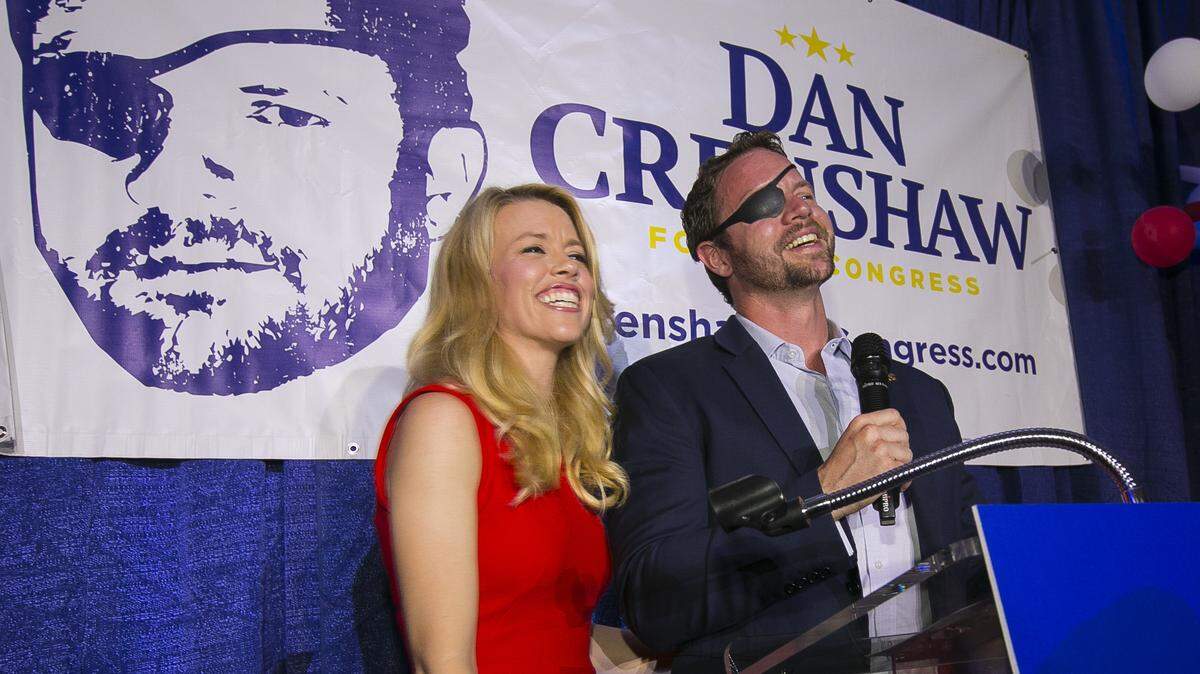 Republican congressman-elect Dan Crenshaw reacts to supporters with his wife, Tara, before his victory speech Tuesday in Houston. Crenshaw was the target of a tasteless joke about his war injury by “Saturday Night Live” comic Pete Davidson. A Navy SEAL, Crenshaw was wounded during his third tour in Afghanistan.